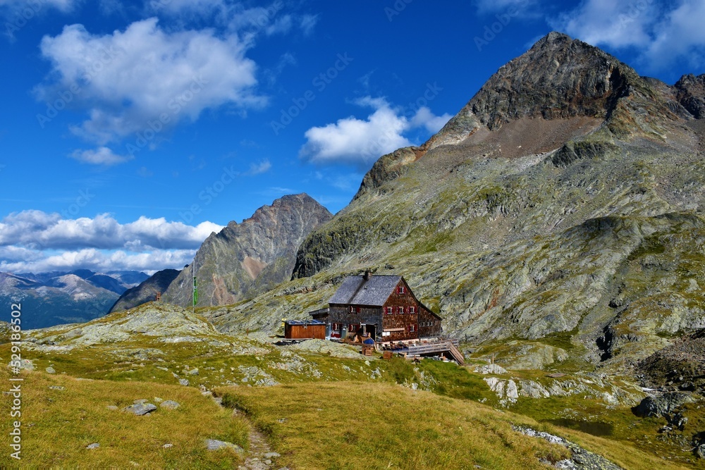 View of Adolf Noßberger Hütte and the peak of Petzeck mountain above in in Gradental valley in Schober group sub-range of Hohe Tauern in Central Eastern Alps, Carinthia, Austria