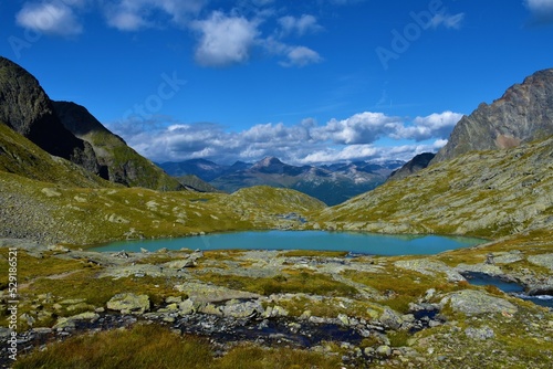 Scenic view of Mittersee alpine lake in Gradentall valley in Schober group sub-range of Hohe Tauern in Central Eastern Alps, Carinthia, Austria and mountains in Goldberg Group behind
