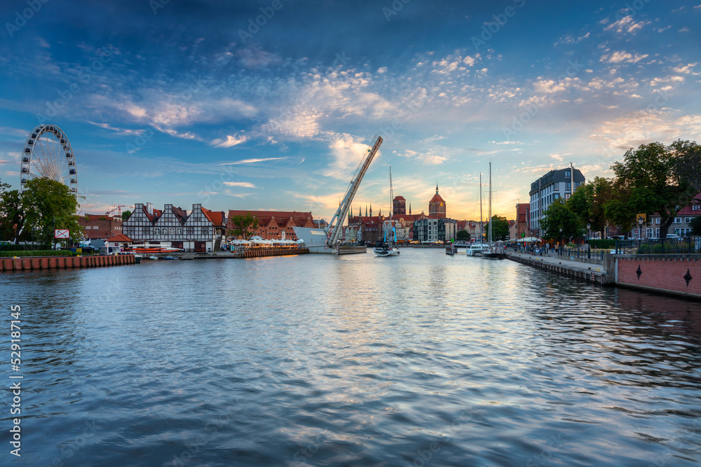 Beautiful Gdansk city reflected in the Motlawa River at sunset. Poland