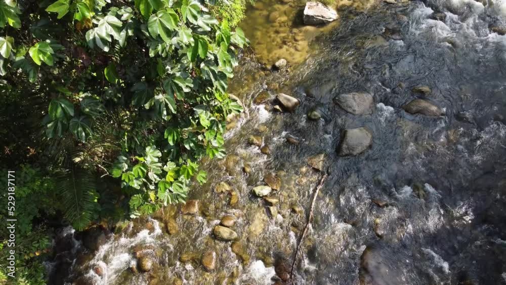 Bird eye view water flow over rock in sun light Bird eye view water flow over rock in sun light