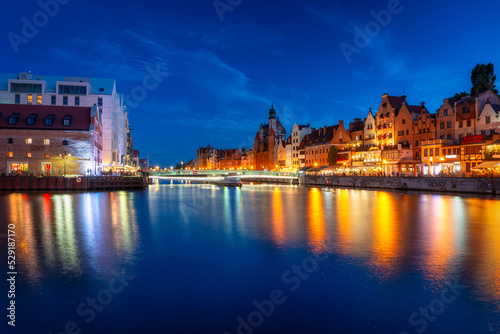 Beautiful architecture of Gdansk city reflected in the Motlawa river at dusk, Poland