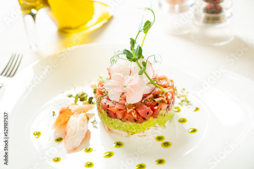 salmon tartare with avocado and edible flowers
