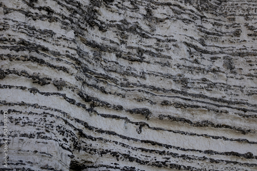 Close up on a cliff at Etretat. The characteristic zebra patterns are visible Close up on a cliff at Etretat. The characteristic zebra patterns are visible