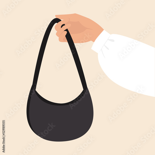 Woman's hand holds a black clutch 