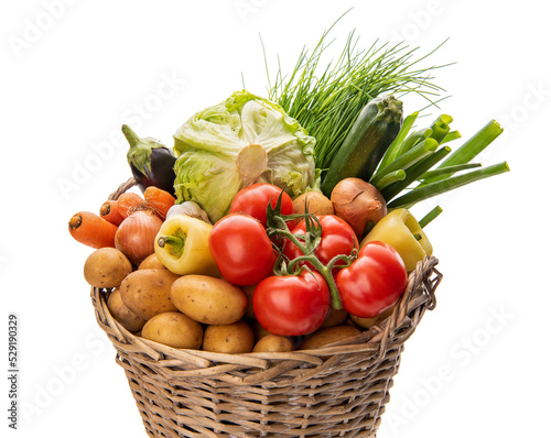 Basket with vegetables. Potatoes  onions  tomatoes  cabbage and other vegetables