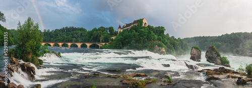 Rainbow dramatic sky panoramic photo of Rhine falls during golden hour, Schaffhausen, Switzerland