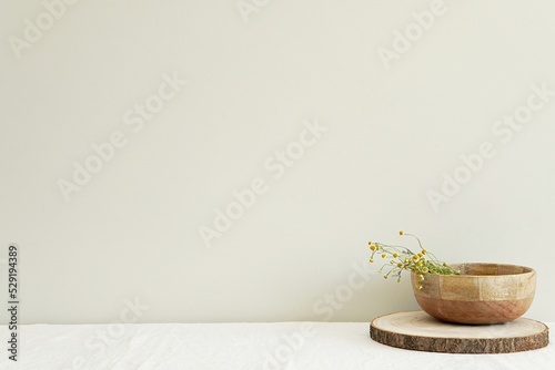 Blank wall mockup for design, framed art, text presentation, minimalist rural composition with wooden bowl, dried flowers on shelf with linen tablecloth.