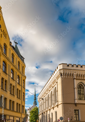 Center of old European city with spire of Saint Peter church and sculpture of...