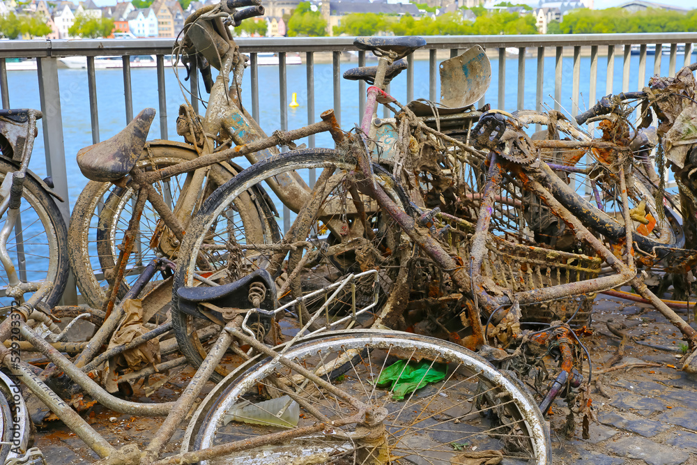Cologne, Germany - July 9. 2022: Pile many old muddy rusty bicycles thrown tossed into the rhine and then salvaged 