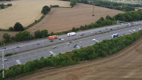 Aerial View of British Motorways With Fast Moving Traffic at Peak Time. M1 J11 and  J7 Motorways Junction Interchange. Time Lapse Shot captured on 7th Sep 2022 photo