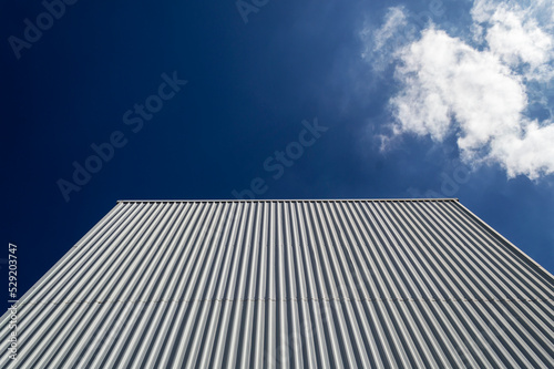 Dark blue sky and building facade in Belo Horizonte. A cloud. Space for advertisement.