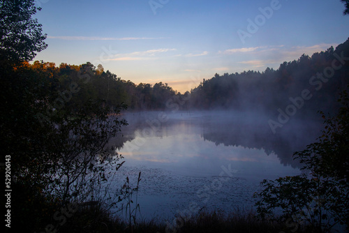 Beautiful early morning foggy lake distant golden hour sky