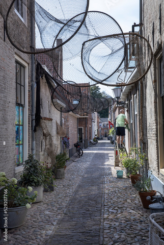 street and fishing nets  city of elburg  gelderland  veluwe  netherlands  historic medieval  cleaning the windows  