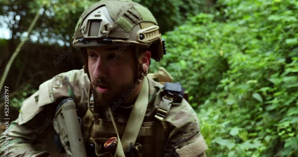a Ukrainian soldier in ammunition and a helmet aims with a sniper rifle and checks the perimeter. soldier is fighting. tactical walking. big plan