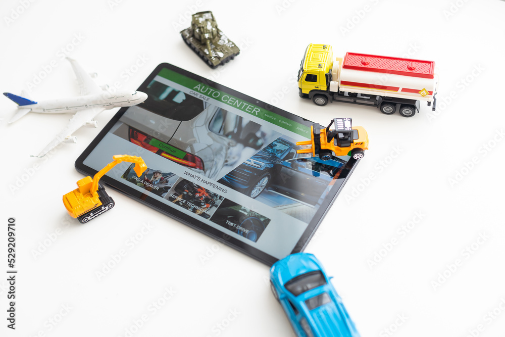different types of toy transport and a tablet