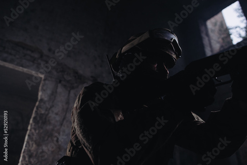 A military man with a weapon in his hands, silhouette photo.