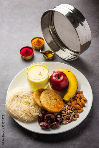 Sargi - pre-dawn meal for karwa chauth or karva chauth puja served with Chalni or strainer and diya photo