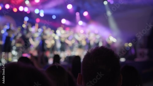 Crowd dancing and applauding to brass band
