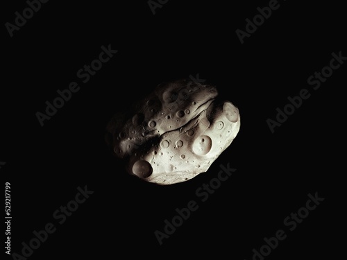 Meteorite on a black background. Asteroid covered with craters in space, surface of the space rock. © Nazarii