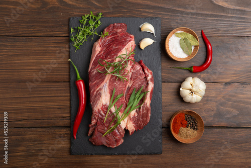 Raw beef steak on wooden table top. Healthy food concept. beef cut and spices for cooking bbq sauce