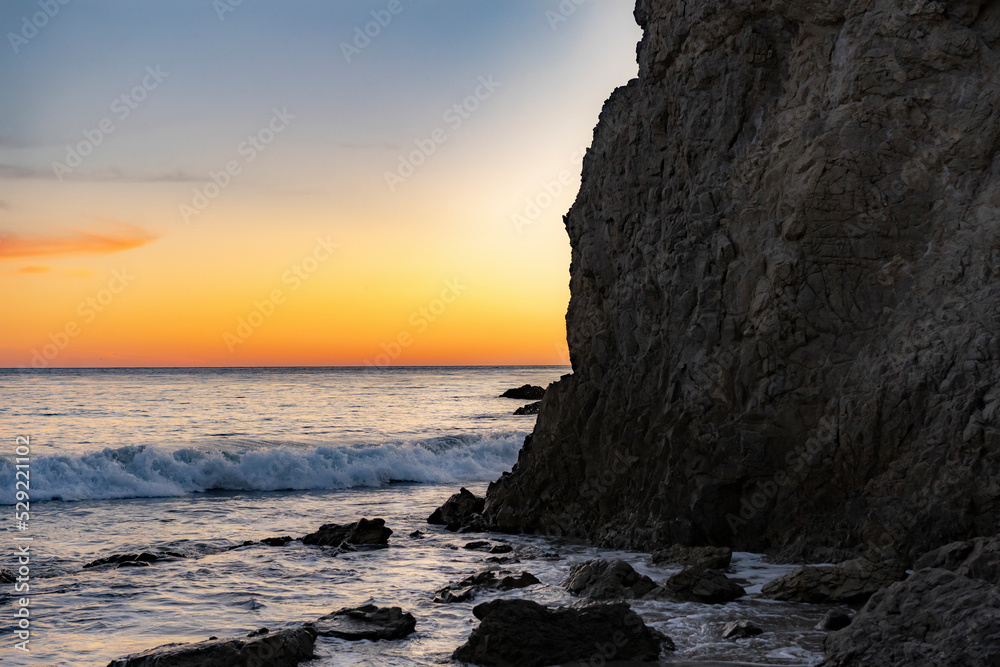Fototapeta premium Sunset by the ocean at El Matador Beach.Malibu, California