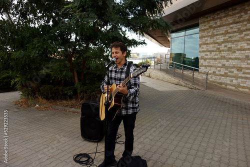 guitarist man singing in a public place square
