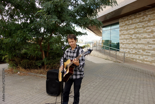 guitarist man singing in a public place square