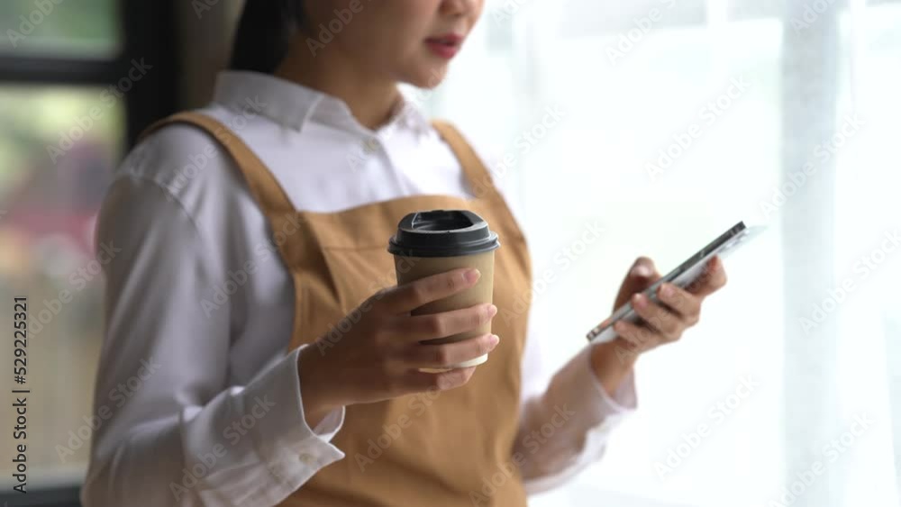 Happy asian woman in apron working at coffee shop. Happy asian woman in apron working at coffee shop.