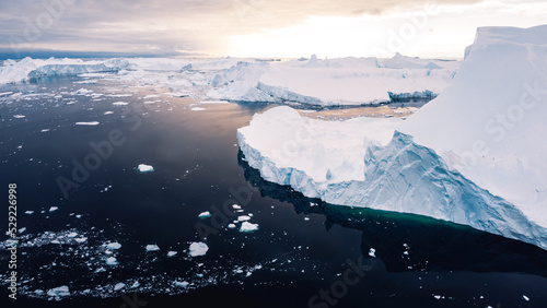 Aerial view of ilulissat icefiord in greenland with enourmous icebergs on sunny day photo