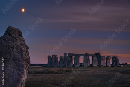 stonehenge with moon on dawn