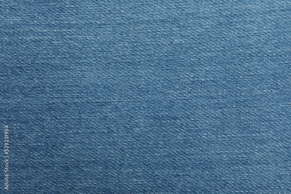 Texture of blue jeans as background, closeup