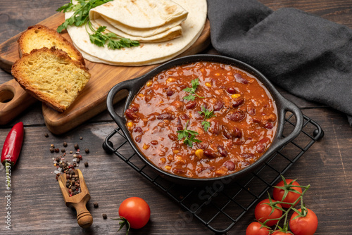 Bean and corn soup or ragout, red bean stew on a wooden background. Food Protein Vegan dish