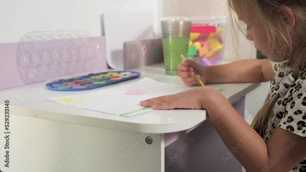 Talented Creative Child Girl Female Artist Draws with Her Hands on Paper, Using Fingers Paints Brush Creates Colorful, Kid Drawing on table at Home. Painter Creating Abstract Modern Art. Childhood Talented Creative Child Girl Female Artist Draws with Her Hands on Paper, Using Fingers Paints Brush Creates Colorful, Kid Drawing on table at Home. Painter Creating Abstract Modern Art. Childhood