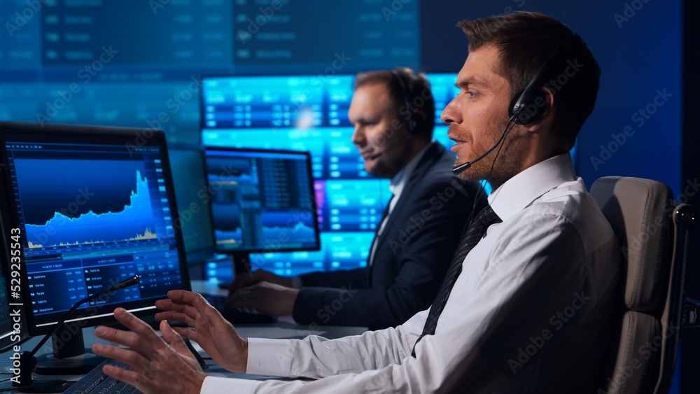 Team of brokers is working in office using workstation and analysis technology. Workplace of professional traders. Global financial markets, business strategy, currency exchange and banking. Team of brokers is working in office using workstation and analysis technology. Workplace of professional traders. Global financial markets, business strategy, currency exchange and banking.
