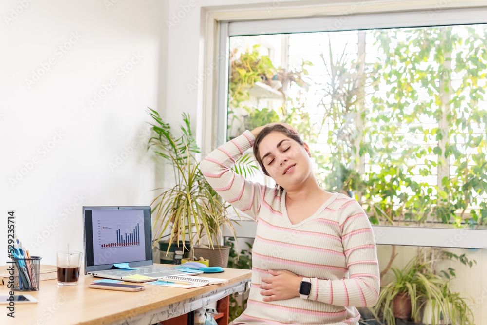 Stressed businesswoman having neck pain.