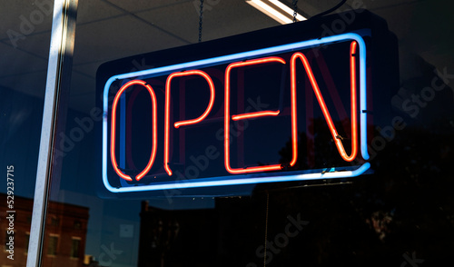 Neon OPEN sign hanging in a retail store window