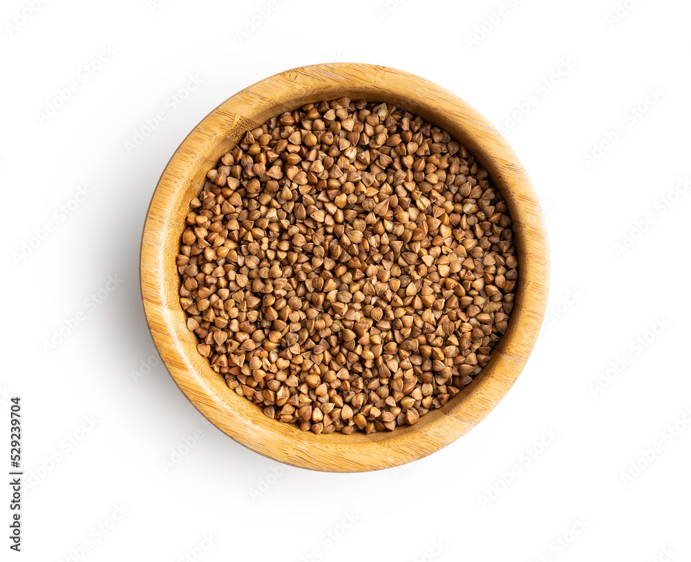 Uncooked buckwheat grain in scoop isolated on white background. Uncooked buckwheat grain in scoop isolated on white background.