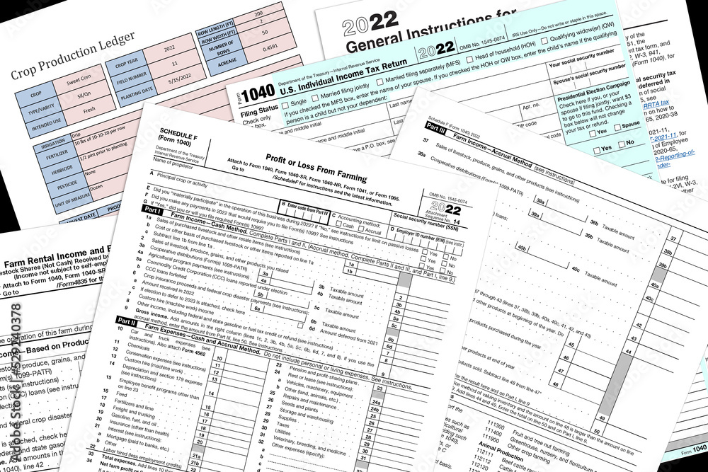 2022 IRS farming tax forms and simulated crop report lay on a desk top. - obrazy, fototapety, plakaty 