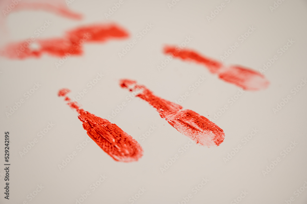 Hand prints in blood on a white table. Hand prints in blood on a white table.