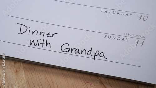 Dinner with Grandpa written on calendar on Grandparents Day - September 11, 2022. photo