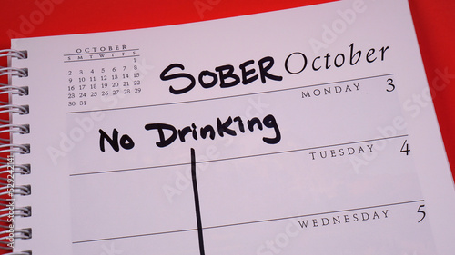 Sober October marked on a 2022 calendar. Sober October is the new and more poetic Dry January. It involves cutting out alcohol for 31 days, often for charity. photo