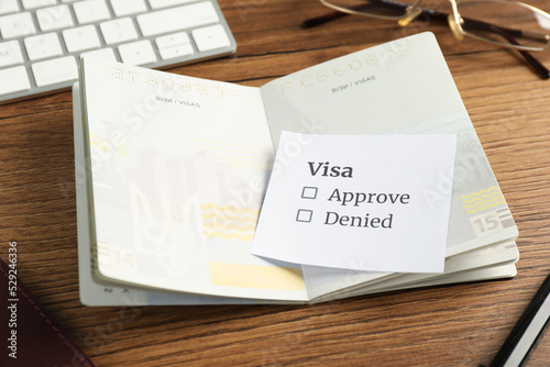 Moldova, Ceadir-Lunga - June 13, 2022: Passport with visa permission on wooden table photo