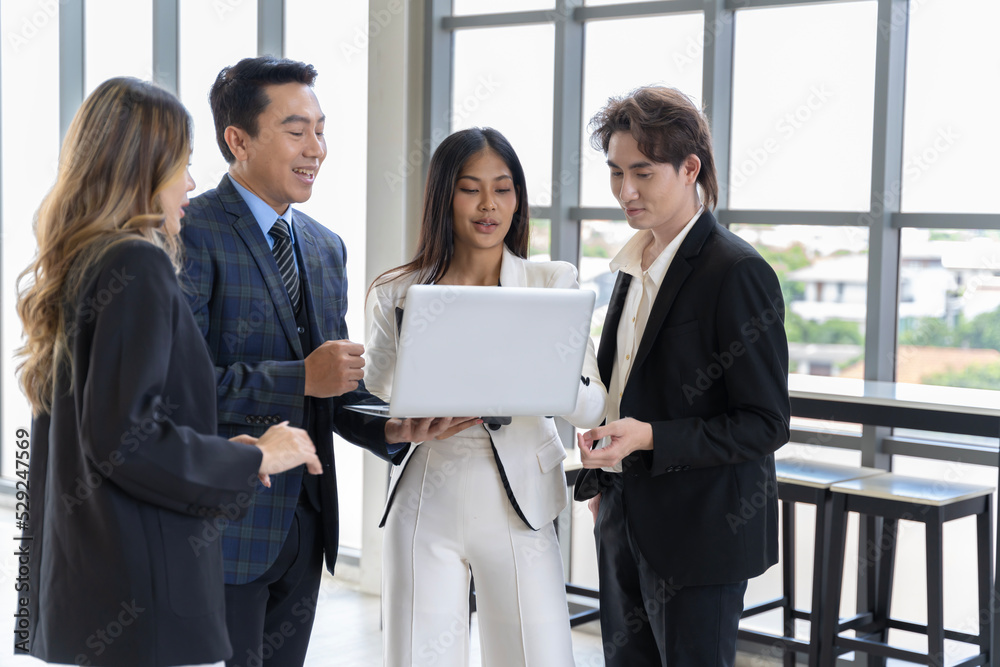 A group of young Asian businessmen Talking and planning work happily and have fun. at the company's office A group of young Asian businessmen Talking and planning work happily and have fun. at the company's office