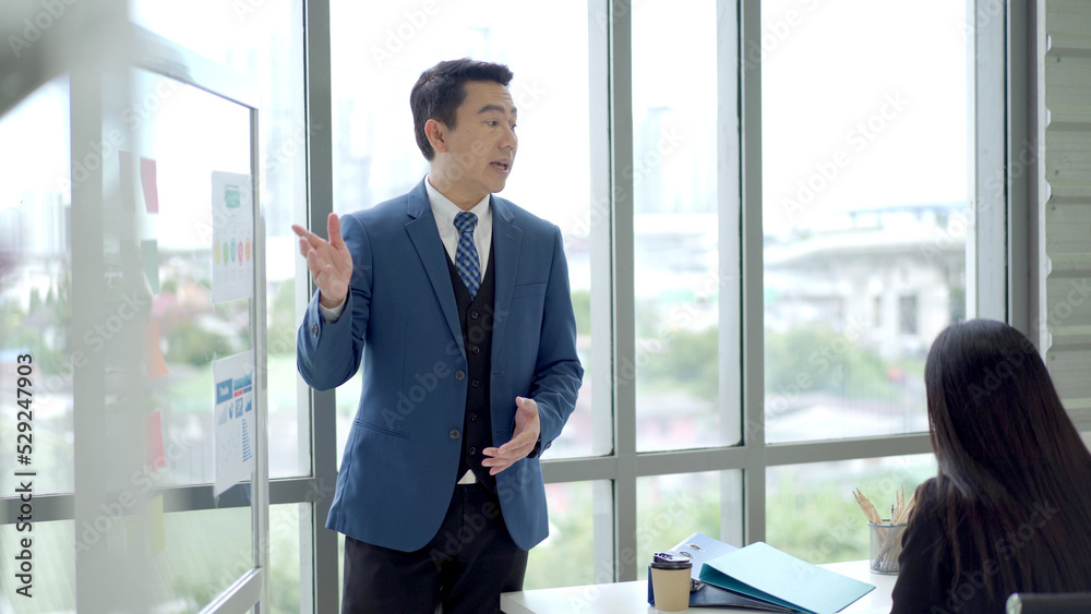 Asian senior businessman presenting an annual or fiscal year business plan meeting. Asian senior businessman presenting an annual or fiscal year business plan meeting.