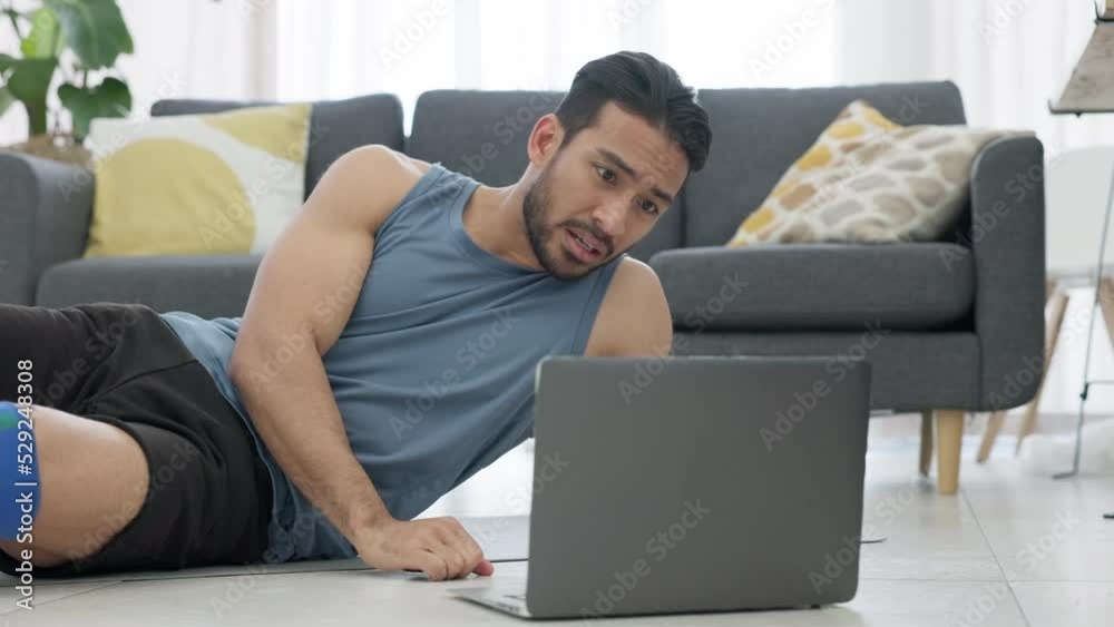 Man tired from fitness training with online workout video on laptop, breathing fast after cardio exercise for healthy body and reading instruction for sports on the internet. Asian man doing crunches Man tired from fitness training with online workout video on laptop, breathing fast after cardio exercise for healthy body and reading instruction for sports on the internet. Asian man doing crunches