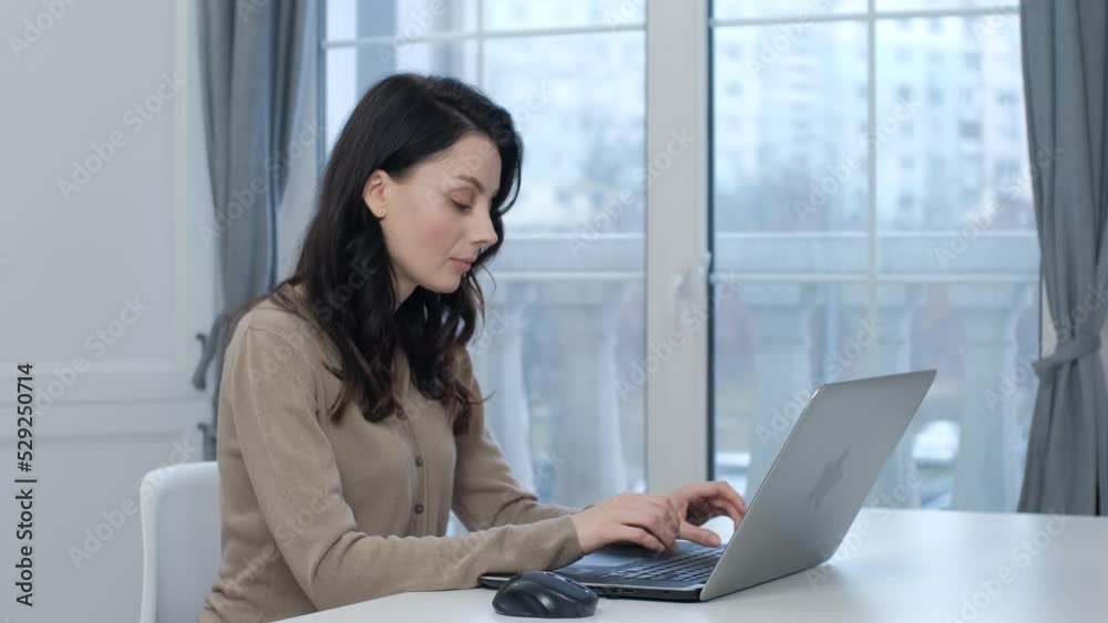 Young woman typing text on laptop. Beautiful white person working on modern notebook pc at home. Ukrainian female programmer coding on computer Young woman typing text on laptop. Beautiful white person working on modern notebook pc at home. Ukrainian female programmer coding on computer