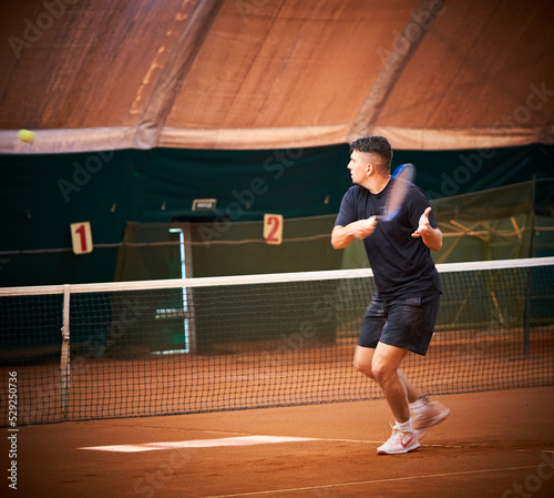 athlete trains on the court to play tennis