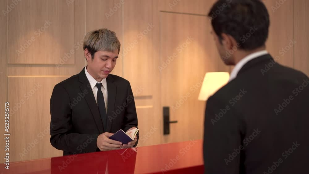 Businessman making a hotel check-in at reception desk. Businessman making a hotel check-in at reception desk.