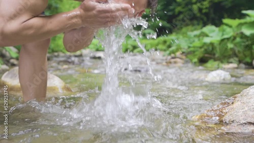 Sporty man in front of waterfall. Slow motion.
Young man spreading his hands in front of the waterfall. Peaceful and happy.
