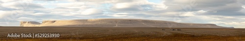 Panorama of Caswell Tower, Nunavut, Canada with hikers